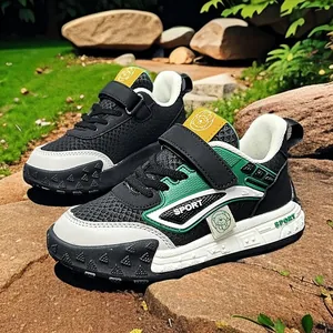 Fashionable kids' sneakers with durable leather surface and green accents for outdoors