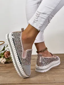 Primer plano de mocasines con plataforma de purpurina multicolor y suela de caucho blanca.