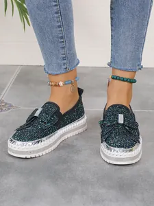 Stylish women's glitter flat shoes featuring a bow detail and rhinestone platform sole
