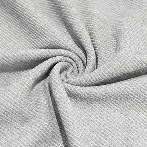 Gros plan détaillé sur la texture du tissu en maille gaufrée gris clair pour vêtements