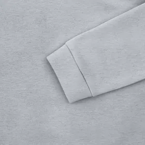 Détail macro montrant la texture du poignet côtelé d'un sweat à capuche gris pour homme