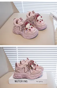 Detailed view of pink fur-lined winter sneakers for kids with cartoon charm ornament