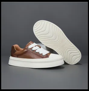 Detail view of brown leather casual sneakers showing the side profile and wavy outsole