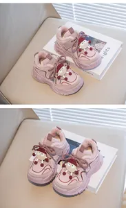 Detail view of pink kids winter sneakers with cute cartoon decor and warm fur lining