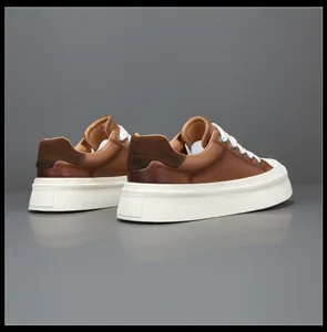Premium brown leather thick sole sneakers featuring wide laces and stylish rear profile.