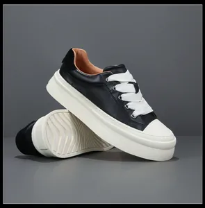 Detailed view of men's genuine leather black sneakers with white platform soles and wide laces