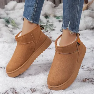 Detalle de botas de nieve marrones con suela gruesa y forro de piel sintética
