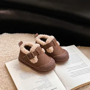 Detail view of brown winter baby walker shoes with warm fleece lining and buckles