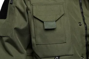 Macro shot of the chest pocket and durable fabric on this green tactical military jacket