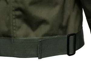 Detailed macro view of durable army green tactical jacket fabric and adjustable hem buckle.
