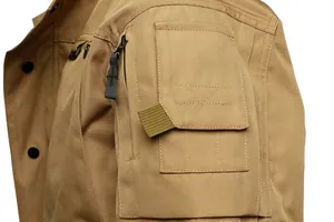 Close-up of durable shoulder pocket and fabric texture on khaki tactical jacket