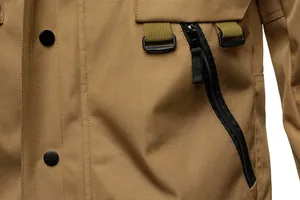Macro detail of a khaki tactical jacket showing heavy-duty zipper and fabric texture