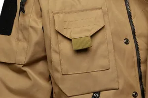 Close-up of tactical jacket pocket showing durable canvas texture and sturdy zippers