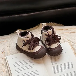 Cozy toddler winter boots with quilted pattern and warm lining on a soft cream sweater