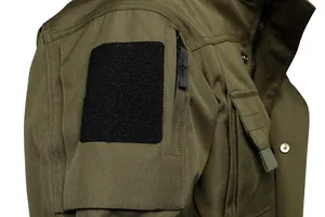 Detail view of olive green tactical jacket with shoulder velcro patch and sleeve zipper