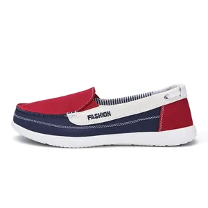 Detailed side view of men's casual canvas loafer in red, white and navy blue