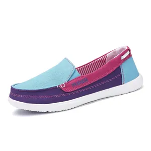 Detail view of a colorful canvas walking shoe featuring blue, purple, and pink panels.