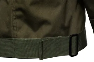 Detail of army green tactical jacket showing durable fabric texture and adjustment buckle.
