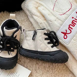 Quilted toddler winter boots with soft soles for baby walking, beige and black design.