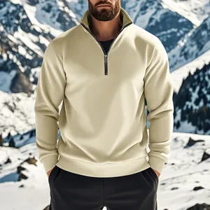 Sweat-shirt beige à quart de zip pour homme présenté devant un paysage de montagne enneigé