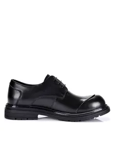 Side profile detail of black genuine leather dress shoes with unique big-toe design
