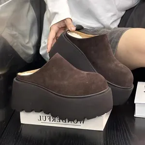 Vue détaillée de mules à plateforme en daim marron avec semelles compensées et polaire.