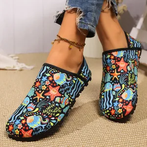 Close-up of vibrant ocean pattern on soft sole indoor shoes for yoga and dancing.