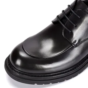 Close-up of black genuine leather men's derby shoes with formal round toe and laces