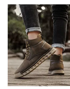 Side view of men's outdoor hand-stitched leather boots in a walking pose outdoors
