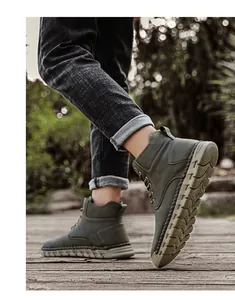 Detailed view of men's olive green outdoor high-top boots featuring hand-stitched soles