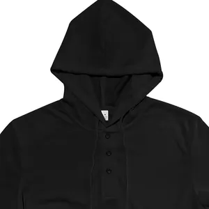 Détail d'un sweat à capuche noir en maille gaufrée avec patte de boutonnage Henley