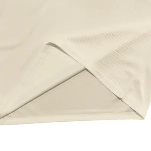 Gros plan détaillé du tissu gaufré beige montrant la texture et la qualité de l'ourlet