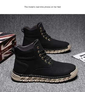 Detail of men's outdoor high-top boots with hand-stitched soles and gold eyelets