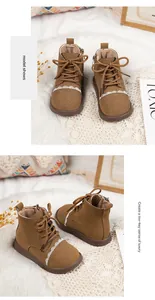Detailed macro view of girl's brown suede boots featuring elegant white lace trim.