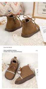 Close-up of brown suede children's boots featuring white lace trim and side zipper details.