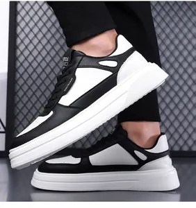 Vista laterale di sneakers casual da uomo bianche e nere con suole bianche spesse