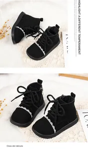 Elegant black leather boots for girls featuring delicate lace trim and soft soles.