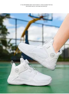 Detailed view of white breathable mesh kids basketball shoes featuring a rotary buckle system
