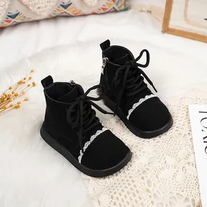 Black children's ankle boots with white lace trim and side zipper closure.