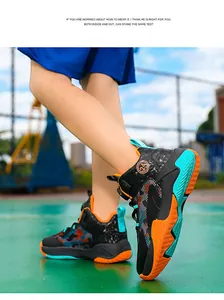 Close-up action shot of kids high-top basketball shoes with rotary buckle in outdoor court