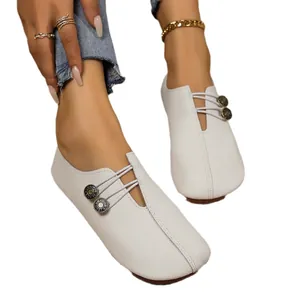 White soft leather flat loafers for women with decorative buttons and elastic laces.