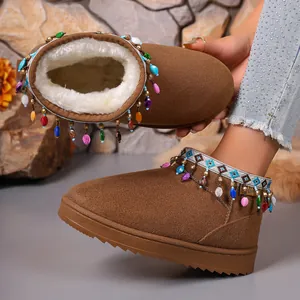Detailed view of brown snow boots with colorful bead fringes and plush lining
