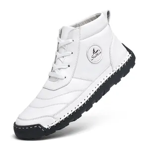 Detail of white men's high-top leather boots with black sole and hand-stitched seams