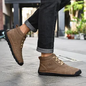 Detail of hand-stitched brown high-top casual boots for men in an urban setting