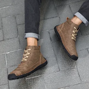 Top-down view of men's brown high-top Martin boots with hand-stitched detailing.