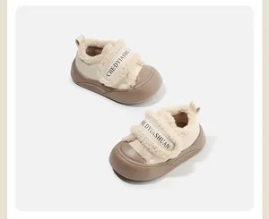 Detail of beige baby winter shoes with soft faux fur lining and adjustable velcro strap.