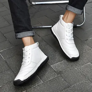Close-up detail of white hand-stitched high-top men's Martin boots with black soles