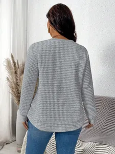 Back view detail of a grey waffle textured casual pullover sweatshirt for women.