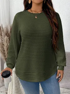 Close-up detail of women's olive green quilted sweatshirt with grid texture and round neck