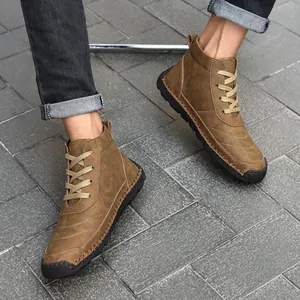 Casual brown men's leather Martin boots with hand-stitched details on grey tile floor